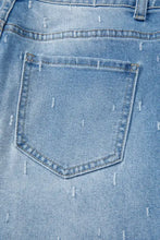 Light-wash denim tummy control raw hem jeans with subtle distressed white stitching detail and tummy control fit