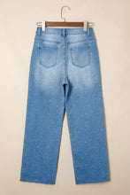Light-wash denim tummy control raw hem jeans with subtle dotted pattern and distressed detail straight-leg cut
