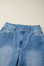Light-wash denim tummy control raw hem jeans with subtle stitched arrow pattern and distressed detail