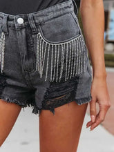 Distressed fringe denim shorts with rhinestone fringe and pockets