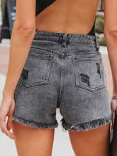 Women’s distressed fringe denim shorts with frayed hems and pockets