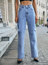 Light-wash denim distressed high waist wide-leg jeans with ripped knees for a trendy casual look