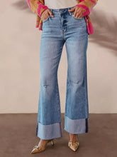 Distressed high waisted flare jeans in light wash denim with rolled cuffs for a perfect fit and best results