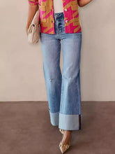 Distressed high-waisted light-wash denim flare jeans with rolled cuffs offer a perfect fit for best results