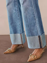 Tan patent leather pointed-toe heels with gold-tone horsebit detailing styled with distressed high-waisted flare jeans for a perfect fit