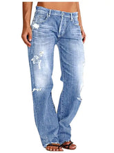 Light-wash denim distressed loose fit jeans with ripped details and a flared leg cut for casual wear