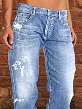 Distressed loose fit light-wash denim jeans with intentional distressing and frayed patches on the thighs