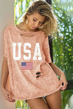 Distressed peach t-shirt with washed American flag graphic