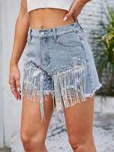 Distressed pearl trim denim shorts with pockets and silver fringe