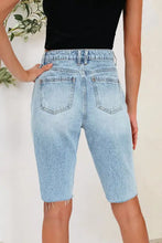 Distressed pocketed light wash denim cutoff Bermuda shorts