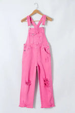 Distressed pocketed wide strap denim overalls in hot pink with frayed hems