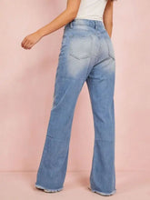 Light-wash denim bootcut jeans with distressed raw frayed hems offering modern pairing advice for casual wear