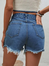 Distressed raw hem denim shorts with high-waisted fit