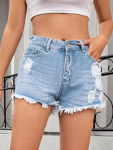 Light blue distressed raw hem denim shorts with frayed hems