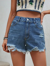 Light blue distressed raw hem denim shorts with frayed hems