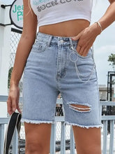 Distressed raw hem denim shorts with fringed hem and silver chain