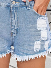 Distressed raw hem denim shorts with light-wash frayed hems