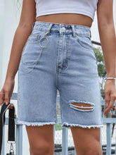 Light wash high-waisted raw hem denim shorts with frayed hem