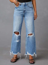 Light-wash denim flare jeans with distressed raw hem, high-rise fit, wide legs, and ripped knees