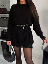 Black ribbed knit sweater dress with lace trim and gold-tone belt buckle