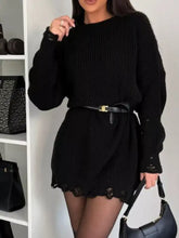 Black ribbed knit sweater dress with lace trim and gold-tone belt buckle