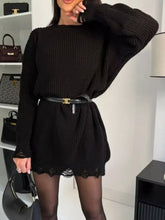 Black ribbed knit sweater dress with lace trim and gold-tone belt buckle