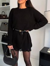 Black ribbed knit sweater dress with lace hem trim and logo belt buckle
