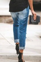 Blue denim distressed straight leg jeans with rolled cuffs and distressed details for casual wear