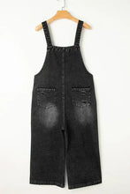 Distressed wide strap denim overalls with cropped legs and pockets