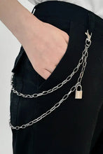 Hand in pocket with double layered iron chain belt and silver padlock charm