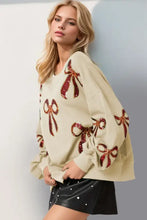 Beige oversized Christmas bow sequin sweatshirt with red bow appliques