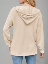 Woman modeling beige drawstring dropped shoulder long sleeve hoodie
