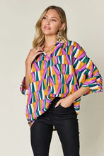 Vibrant double take full size geometric notched dolman sleeve blouse with bold purple orange green and white stripes size guide included