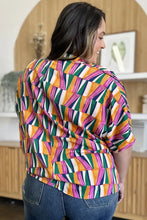 Double Take full size geometric notched dolman sleeve top with bold orange green pink and white hues perfect for jeans size fitting