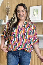 Double take full size geometric notched dolman sleeve top with vibrant orange green pink and white pattern perfect for jeans size styling
