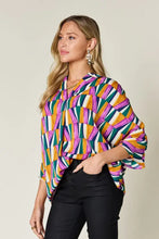 Vibrant geometric-patterned double take full size notched dolman sleeve blouse with bold purple green orange stripes for jeans size