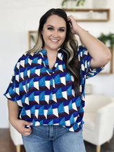Blue and white geometric patterned plus-size blouse with short notched sleeves in lightweight fabric for casual wear