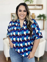 Blue and white geometric patterned short sleeve blouse with v neckline in lightweight breathable fabric for casual wear