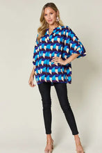 Double take full size geometric notched half sleeve blouse in vibrant blue and white with a loose flowing silhouette