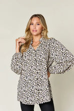 Women’s long-sleeved button-up blouse in black and cream leopard print featuring a full size flattering fit