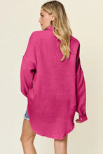 A vibrant fuchsia oversized double take full size pocketed textured button up shirt dress with long sleeves