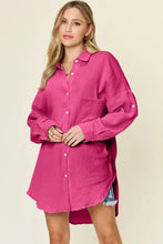 A vibrant fuchsia double take full size pocketed texture button up shirt with long sleeves and rolled cuffs