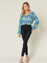 Double take full size printed balloon sleeve blouse with vibrant blue green and red geometric pattern and long sleeves