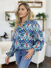 A vibrant long-sleeved blouse with bold blue teal red and green geometric ikat pattern double take balloon sleeve blouse