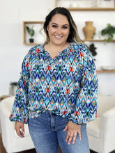 A vibrant double take full size printed balloon sleeve blouse with bold geometric pattern in blue green red and white