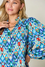Double take full size printed balloon sleeve blouse with vibrant blue green ikat pattern and red accents on long sleeves