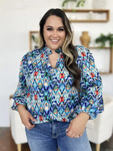 Double take full size printed balloon sleeve blouse with vibrant blue red and green ikat pattern and tie neck collar