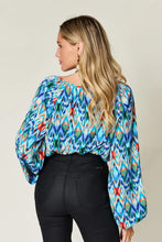 Double take full size printed balloon sleeve blouse in vibrant blue teal red and green geometric pattern with puffed sleeves