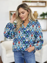 Double take full size printed balloon sleeve blouse featuring vibrant blue red and green ikat pattern with long puffed sleeves