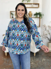 A vibrant double take full size printed balloon sleeve blouse with bold geometric ikat pattern in blue teal red and white